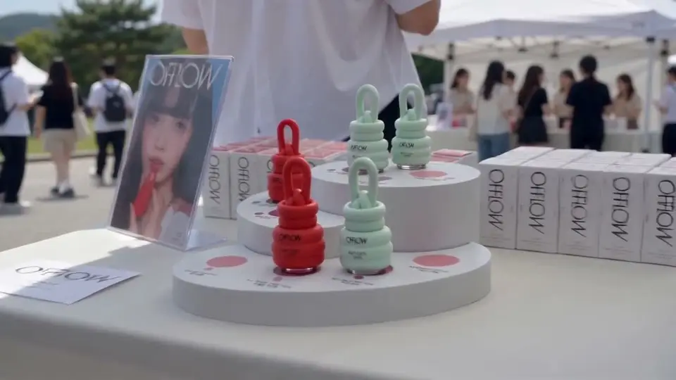 Mint and red OFFLOW lip products displayed beside boxed products on a white table at MAUM Market.